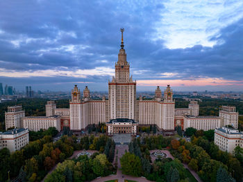 Buildings in city against cloudy sky