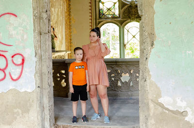 Portrait of friends standing against wall