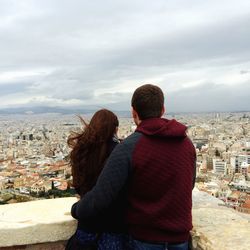 Rear view of woman looking at cityscape