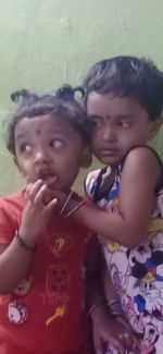 Portrait of cute girl with mother and daughter in background