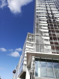 Low angle view of modern building against blue sky