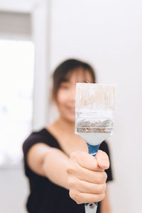 Midsection of woman holding ice cream