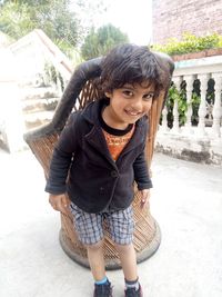 Portrait of smiling girl standing outdoors