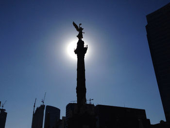 Low angle view of statue against clear blue sky