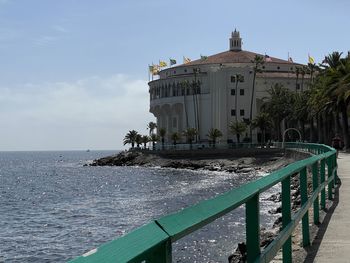 Building by sea against sky