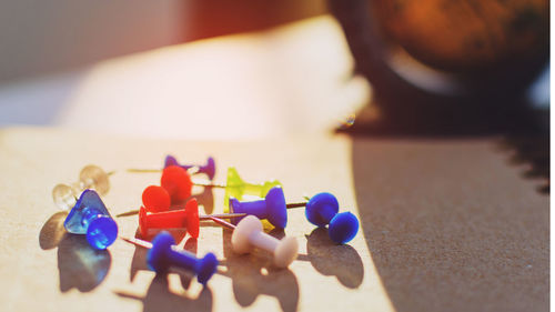 High angle view of thumbtacks on table