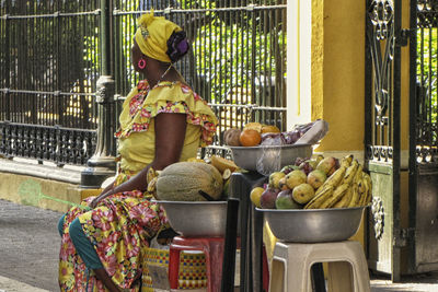 Rear view of woman sitting outdoors