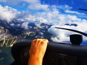 Midsection of man driving car against sky