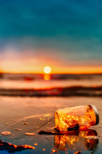 Close-up of sea against sky during sunset