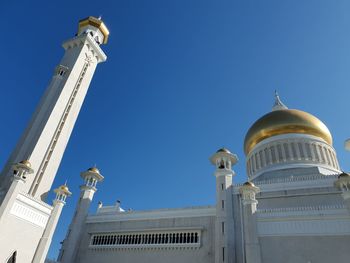 Low angle view of building mosque in brunei against a clear blue sky