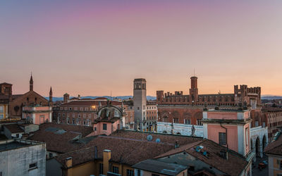 High angle view of buildings in city at sunset