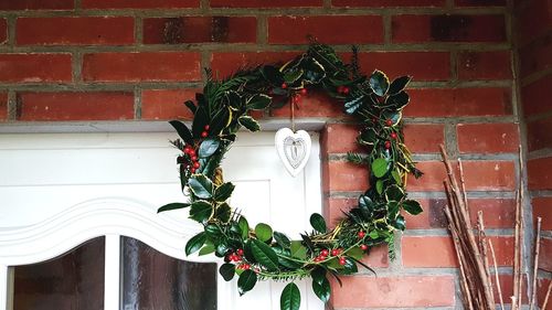 Low angle view of christmas decoration against wall