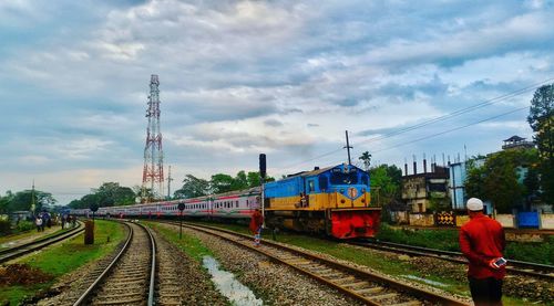 Train on railroad tracks against sky