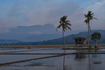 Pier on sea with mountain in background