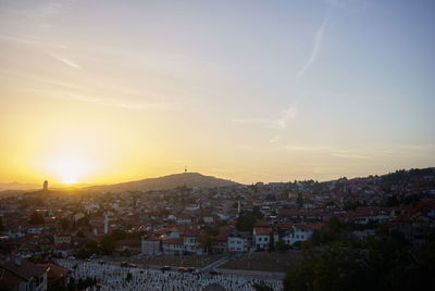 High angle shot of townscape against sky at sunset