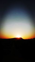 Scenic view of silhouette mountain against sky during sunset