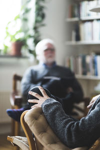 Male patient sitting with therapist in home office