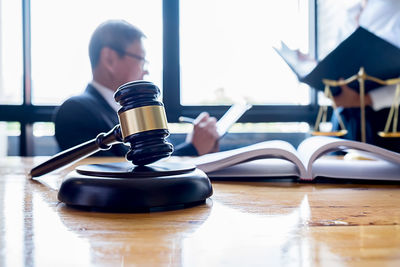 Man holding book on table