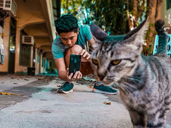 Full length of man holding cat