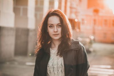 Portrait of beautiful young woman in city