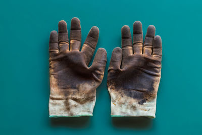 Close-up of hand against blue background