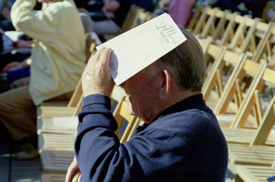 Senior man sitting at outdoor event