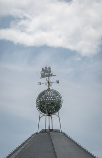A glitter ball and ship weather vane