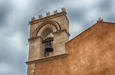 Ancient belltower, iconic landmark located in the central square of taormina, sicily, italy