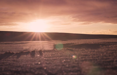 Scenic view of field against sky during sunset