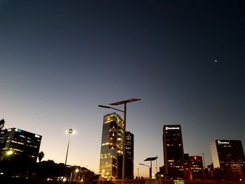 Low angle view of illuminated buildings against sky at night