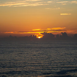 Scenic view of sea against romantic sky at sunset