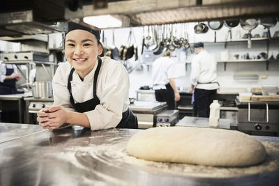 Portrait of happy man working in kitchen