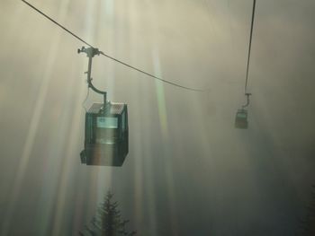 Overhead cable cars in foggy weather