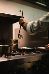 Midsection of man preparing food in kitchen