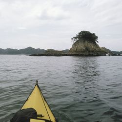 Close-up of yellow boat in sea against sky