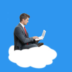 Digital composite image of young man using laptop on cloud against blue background