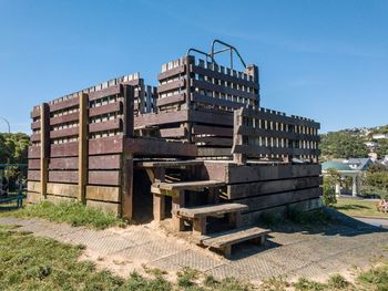 View of abandoned factory against clear blue sky