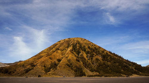 Scenic view of mountain against cloudy sky