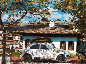 Car on street against buildings