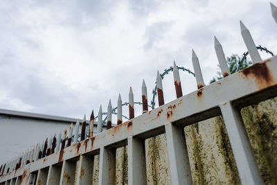 Low angle view of fence against the sky