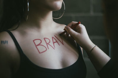 Close-up of woman hand with text