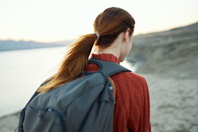 Rear view of woman looking at camera