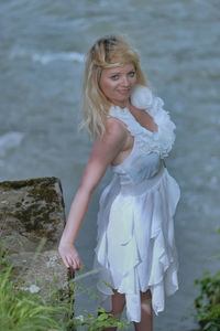 Portrait of smiling woman standing in water