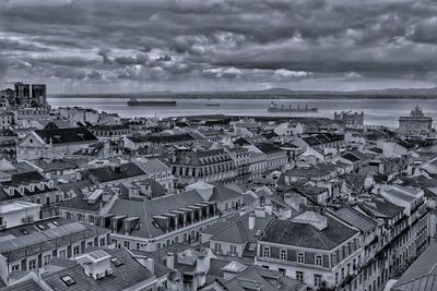 High angle view of townscape by sea against sky