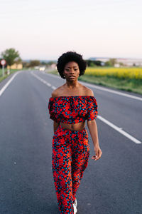 Young woman walking on road