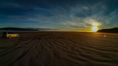 Scenic view of desert against sky during sunset