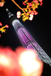 Low angle view of illuminated lights against sky at night