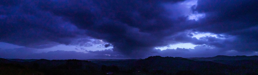 Scenic view of storm clouds over mountains