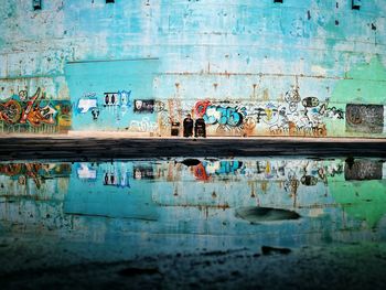 Reflection of building in puddle during rainy season