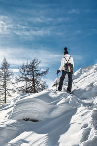 A woman on a snowshoeing trip on a sunny day